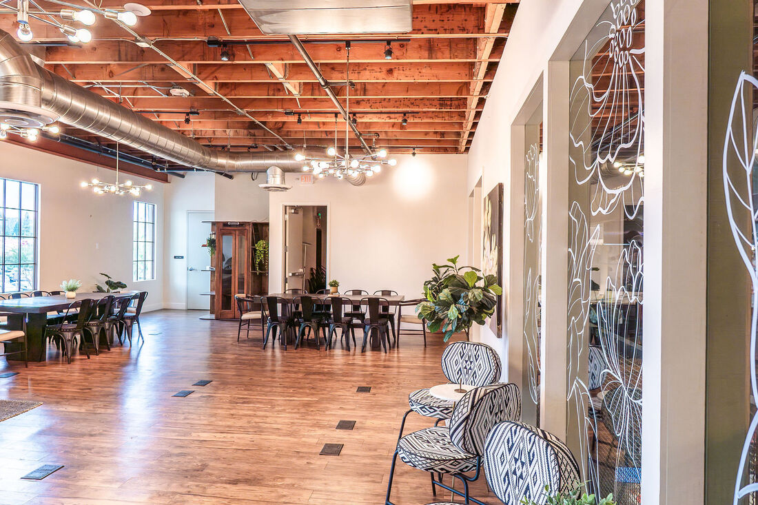 The Meeting Place - Full overview with exposed wood ceiling and multiple seating areas